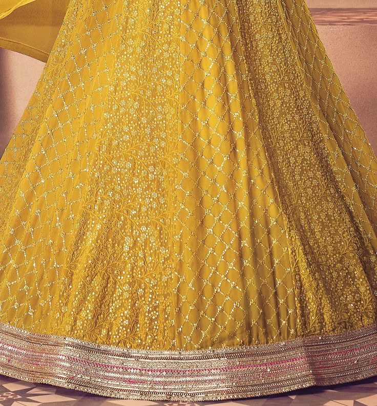 COLOR : Saffron Yellow FABRIC : Top - Premium Georgette, Bottom - Santoon, Dupatta - Nazmin Chiffon WORK : Heavy Resham Embroidery, Zari, Stones, Heavy Sequin Work, Lace Border OCCASION : Wedding, Reception, Sangeet, Mehendi, Party Wear, Bridal Wear READY-TO-WEAR : NoSTITCHING : Available as semi-stitched fabric, can be stitched using standard size option (+$30). Note: There might be a slight color variation due to lighting and flash used during photoshoot. The bright shade seen is the best clos Mehendi Party, Wedding Anarkali, Resham Embroidery, Saffron Yellow, Pakistani Dresses Casual, Embroidered Wedding, Anarkali Suit, Suit Fabric, Lace Border