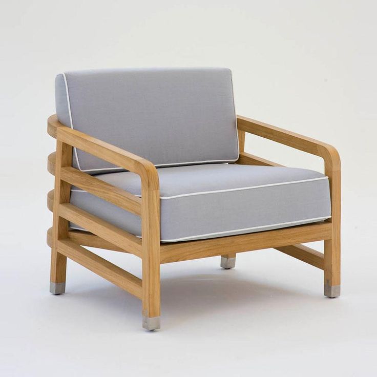 a wooden chair with grey cushions on it's back and arm rests against a white background