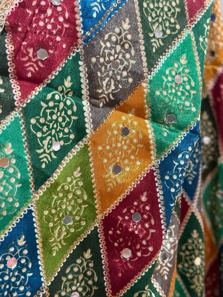 Experience the beauty of traditional Phulkari style with our Multicolor Dupatta. Made with a soft and luxurious silk finish, this dupatta features real mirror accents and stunning designs. Its heavy-weight construction makes it perfect for special occasions like Navaratri. Elevate your wardrobe with this must-have accessory. Multicolor Zari Work Sets For Festive Season, Festive Multicolor Embroidered Anarkali Set With Zari Work, Multicolor Chanderi Bollywood Sets, Festive Anarkali Set With Zari Work And Multicolor Embroidery, Multicolor Bollywood Chanderi Sets, Traditional Draped Lehenga With Mirror Work In Jamawar, Festive Multicolor Dola Silk Set, Bollywood Multicolor Chanderi Sets, Bollywood Style Multicolor Mirror Work Set