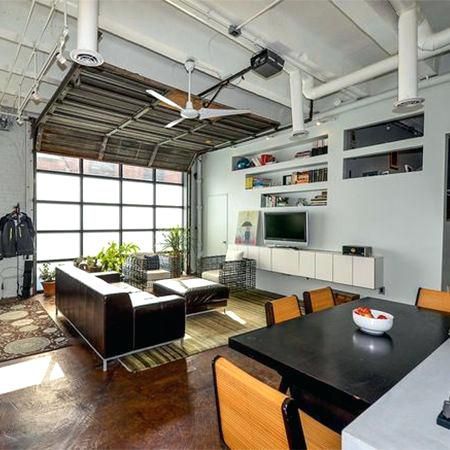 a living room filled with furniture and a flat screen tv on top of a wooden table