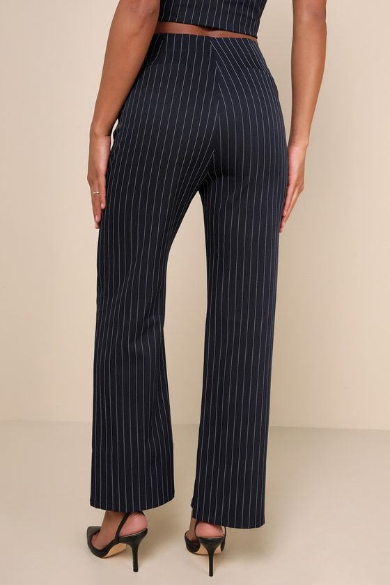 Step into the workweek feeling on top of your game in the Lulus Confident Appeal Navy Blue Pinstripe High Rise Pants! Slightly stretchy woven fabric features a pinstriped pattern throughout as it shapes a high waist and a hidden zip fly with top clasp closure. Sleek silhouette continues with straight legs that end at ankle-length hems. Functional side pockets and decorative welt pockets at back. Pair with the matching top for a complete look! Fit: This garment fits true to size. Length: Floor le Stretch Striped Straight Pants, Chic Stretch Bottoms With Vertical Stripes, Contrast Stripes Bottoms For Workwear, Elegant Pinstripe Ankle-length Bottoms, Elegant Pinstripe Ankle-length Pants, High Waist Bottoms With Vertical Stripes For Business Casual, Pinstripe Wide Leg Bottoms For Workwear, High Waist Vertical Stripes Bottoms For Business Casual, Striped High-waisted Pants For Office