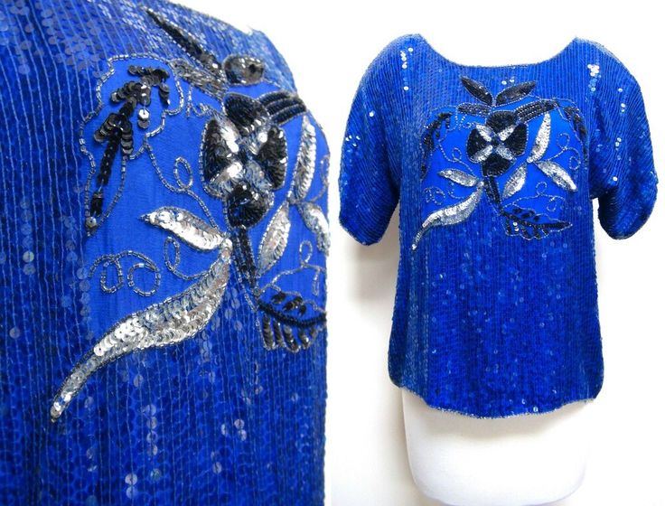 "Beautiful blue sequin top with black and gold detailing. Great for the holidays and New Year's Eve. Label: J.L.B. Materials: 100% Pure Silk Care: Dry Clean Size: Large Bust: up to 44\" Waist: 42\" Shoulder: 21\" Sleeve: 7\" Length: 22\" This garment is in excellent vintage condition." Fitted Sequin Tops For Christmas, Fitted Sequined Christmas Tops, Fitted Christmas Sequin Tops, Glamorous Blue Tops For Party Season, Blue Embellished Party Blouse, Blue Sequin Top For Party Season, Blue Sequin Tops For Party Season, Glamorous Blue Sequined Tops, Festive Blue Sequined Tops