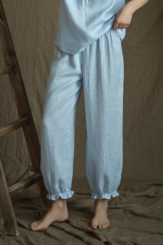 Our new bohemian look pajama - just for your beauty.So cute and feminine look - the ruffles on sleeves and pants create the lightness and softness.Pajama top  drawstringed at neck line and at bottom, reglan short sleeves.Delicate white linen tape decorates short sleeves bottom and front center line.This youthful, beautiful and simple style - for your good and comfy sleep.Top center back length - 38cm ( 15").Pajama bottoms - loose bloomers - gathered with narrow elastic at bottom and with delicat Solid Color Wide Leg Sleepwear For Spring, Solid Wide Leg Sleepwear For Spring, Blue Sleep Pants For Spring, Blue Spring Sleep Pants, Spring Relaxed Bottoms With Elastic Cuffs, Summer Loungewear Pants With Elastic Cuffs, Casual Spring Sleep Bottoms, Comfortable Spring Pants For Relaxation, Comfortable Pants For Relaxation And Spring