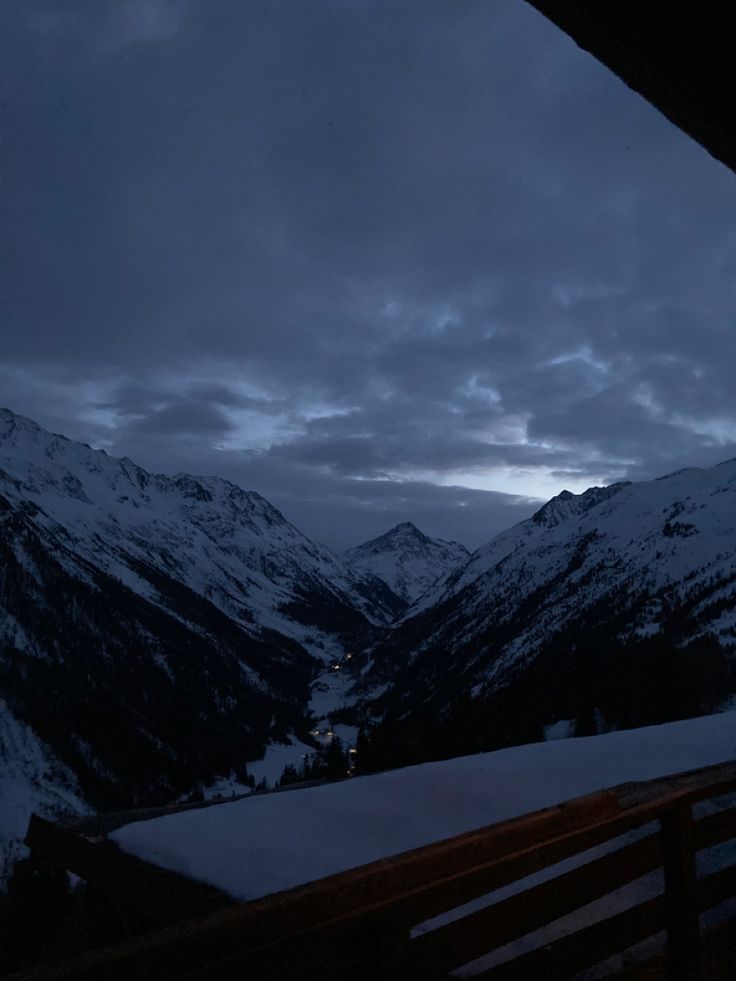 the mountains are covered in snow at night