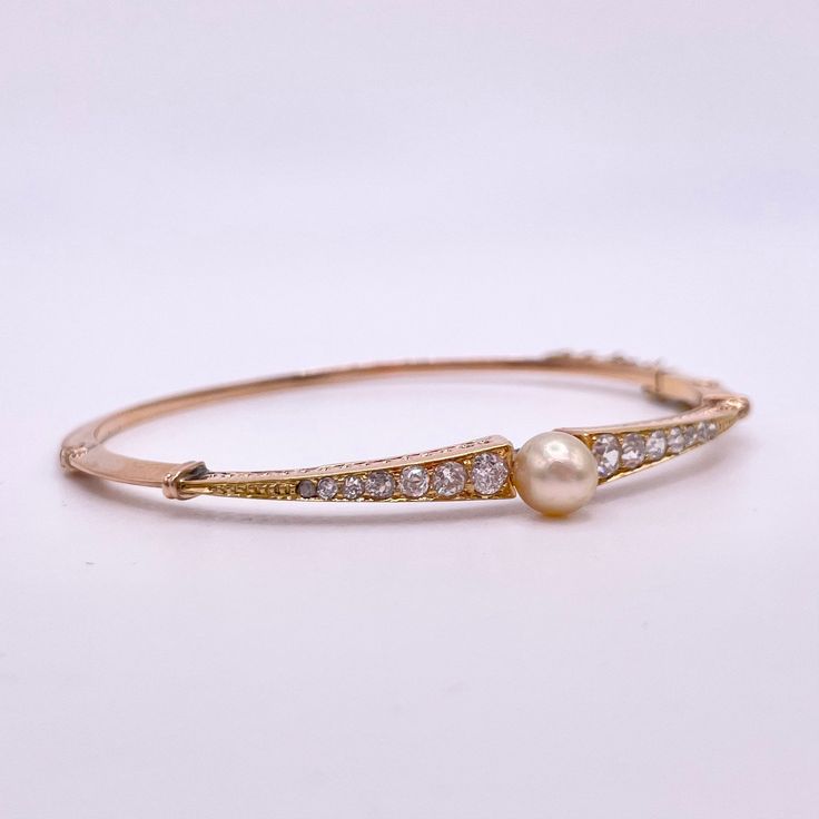 Circa the Victorian Era (late 1800's/early 1900's), this is an authentic pearl and Old Cut diamond hinge cuff bracelet. It's truly a one of one antique piece that isn't found in circulation today. And since it's over a century old, it's basically a historical piece!  14kt yellow gold 6mm cultured pearl 14 Old Cut diamonds (Old Mine & Rose cuts) 2.25 inch opening Vintage Bracelets 19th Century, 18th Century Bracelet, Antique Round Cuff Bracelet For Wedding, Elegant Oyster Cuff Bracelet, Vintage Pearl Bracelet For Formal Occasions, Pearl Wedding Bracelet With 17 Jewels, Classic Gold Pearl Bangle Bracelet, Elegant Pearl Drop Bangle Jewelry, Elegant Pearl Drop Bangle