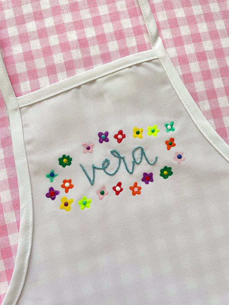 an embroidered apron with the word vera on it