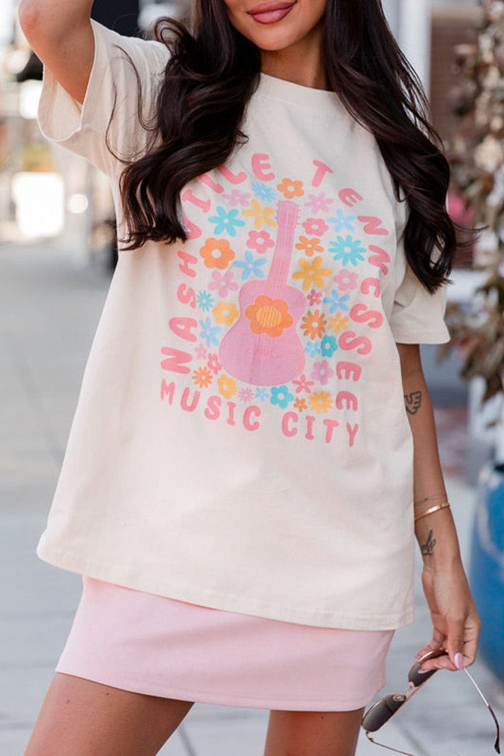 Experience the magic of Music City with our Payson graphic tee! Show off your love for music and the vibrant city life with this stylish graphic tee. Made with high-quality materials and a comfortable fit, this tee is perfect for concerts, festivals, or everyday wear. Join the music revolution and get your Payson tee today! Material:62% Polyester+32% Cotton+6% Elastane Model info: Models are 5'7", Size 2, wearing smalls Size Chart (INCH) Sizes Bust Hem_Width Shoulder Sleeve_Length Length Relax Relax Relax Relax Relax S 39.0 41.3 15.7 7.1 25.6 M 40.9 43.3 16.2 7.5 26.4 L 42.9 45.3 16.7 7.9 27.2 XL 46.1 48.4 17.5 8.3 28.0 2XL 49.2 51.6 18.3 8.7 28.7 Trendy Festival T-shirt With Graphic Print, Casual Summer T-shirt For Concerts, Trendy Summer Concert T-shirt, Trendy T-shirt For Summer Concert, Trendy Summer T-shirt For Concert, Urban Style Summer Tops For Concerts, Trendy Short Sleeve T-shirt For Music Festival, Summer Concert Graphic Tee T-shirt, Summer Concert T-shirt With Letter Print