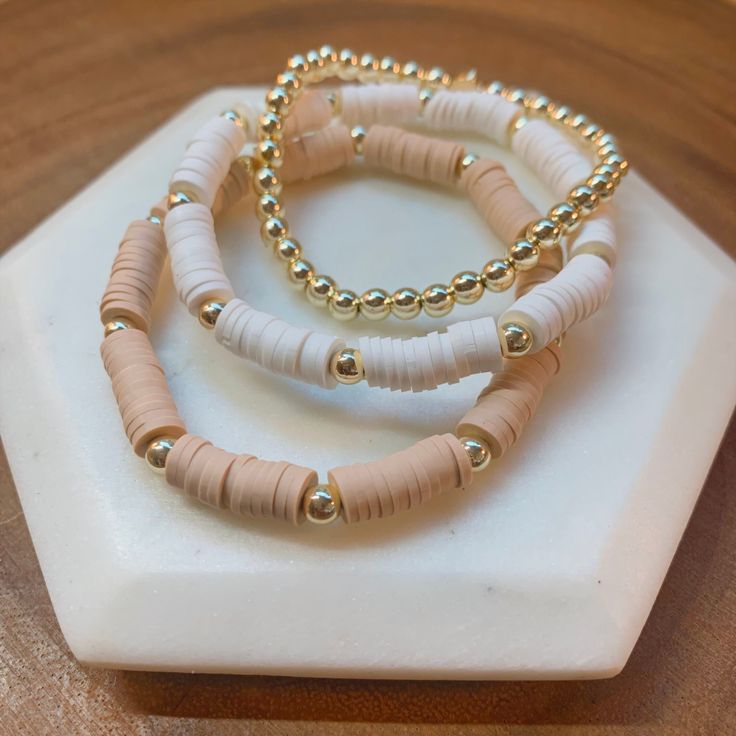 "This listing is for all 3 bracelets - White, Tan & 14K Gold Plated : *Nickel & Lead Free* Materials: 6MM Vinyl Heishi Beads 4MM 14K Gold Plated Hematite Beads HOW TO ORDER: Select size. See photo with size chart for guidance. If you want a size not shown in the drop down, select \"Custom Size\" and list it in the personalization box. All sizes listed are approximate and should not be considered a substitute for proper measuring - please measure your wrist for accurate sizing! If you lik Clay Bead Bracelet Ideas White And Gold, White And Gold Clay Bead Bracelet, Fall Clay Bead Bracelet Ideas, Neutral Bracelets, Make Clay Beads, Heishi Bracelets, Clay Bracelets, Clay Bead Necklace, Heishi Bracelet