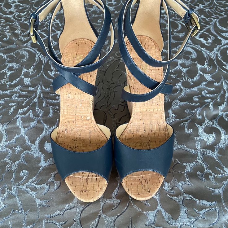 Details Brand New. Never Been Worn. 100% Leather Lining: 100% Synthetic Sole: Rubber Open Toe Buckle Fastening Heel Height: 4.5" Heel Type: Cork Blue Round Toe Wedge Sandals For Formal Occasions, Blue Formal Wedge Sandals With Round Toe, Blue Leather Wedge Heels, Blue Synthetic Wedge Sandals With Ankle Strap, Blue Synthetic Ankle Strap Wedge Sandals, Blue Cushioned Ankle Strap Wedge Sandals, Elegant Blue Wedge Sandals With Round Toe, Blue Synthetic Wedge Sandals With Heel Strap, Blue Wedge Sandals With Cushioned Footbed