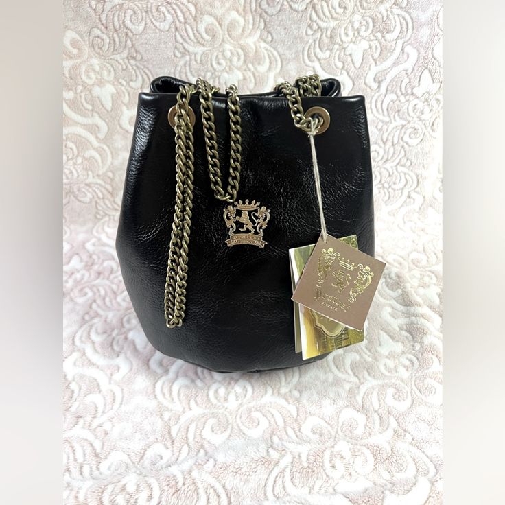 :.: `. Pratesi Firenze Black Leather Chain Italy Bucket Style Handbag - Brand New With Tags! * Pratesi Firenze Bucket Bag New With Tags!! Style: [Bne159] - Bruce Black 100% Genuine Leather Interior Features Brown Satin Lining Snap Closure Rustic Gunmetal/Bronze Hardware Measurements: 9" W X 8.5" H X 6.5" D Strap: 11” Drop / 22” Longest Drop Original Dust Bag Included! Can Be Worn As A Bucket Bag/Shoulder Bag Or Crossbody Purse! Handmade In The Florence Region Of Italy Crafted By Master Artisans Elegant Leather Bucket Evening Bag, Elegant Evening Bucket Bag In Soft Leather, Elegant Soft Leather Evening Bucket Bag, Gift Shoulder Bag With Gold-tone Hardware, Trendy Formal Pouch Bucket Bag, Formal Leather Bucket Evening Bag, Bucket Bag With Gold-tone Hardware For Gift, Luxury Black Bucket Bag As Gift, Elegant Satchel Bucket Bag For Party