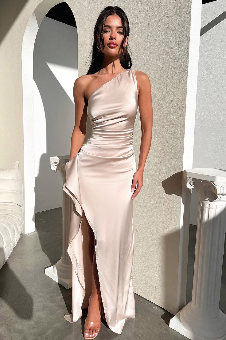 Step out in style with our Elianna Maxi Dress! Show off your sassy side with the one shoulder design and adjustable straps, while the ruched detailing along the sides and side split ensure you look chic and flattering. Put the finishing touches on your look with some nude heels and gold jewellery - it's a glam look that'll have all eyes on you! FABRICATION: 100% Polyester SIZING: Crystal's height is 160cm and wears a size AU 6 / US 2. One Shoulder Strap Dress, Glamorous One Shoulder Dress With Ruched Asymmetrical Neckline, Evening One Shoulder Dress With Ruched Sides, Chic Satin One Shoulder Ruched Dress, Chic Satin One-shoulder Ruched Dress, Chic Ruched Satin One Shoulder Dress, One Shoulder Evening Dress With Ruched Sides, Sleeveless One-shoulder Dress With Ruched Sides For Night Out, Evening One-shoulder Sleeveless Dress With Ruched Sides