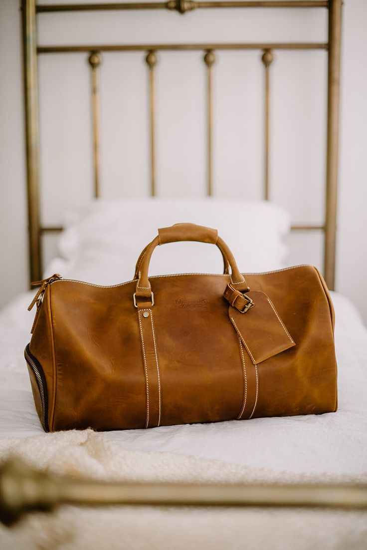 "Handmade Leather Weekend Duffel Bag Travel Bag Suitcase | Genevieve Marcel The Weekend duffel will always be dependable for any short trip. Allowing for items to be placed comfortably, compact, and safe. This high-quality design is there to exaggerate functionality and productivity, with a compartment designed specifically for shoes. Other interior pockets are included which will allow for storage of laptops as well as other accessories. It's completed with a comfortable leather handle will all Bag Suitcase, Round Bag, Travel Duffel, Duffel Bags, Duffel Bag Travel, Short Trip, Bag Travel, Handmade Leather, Duffel Bag