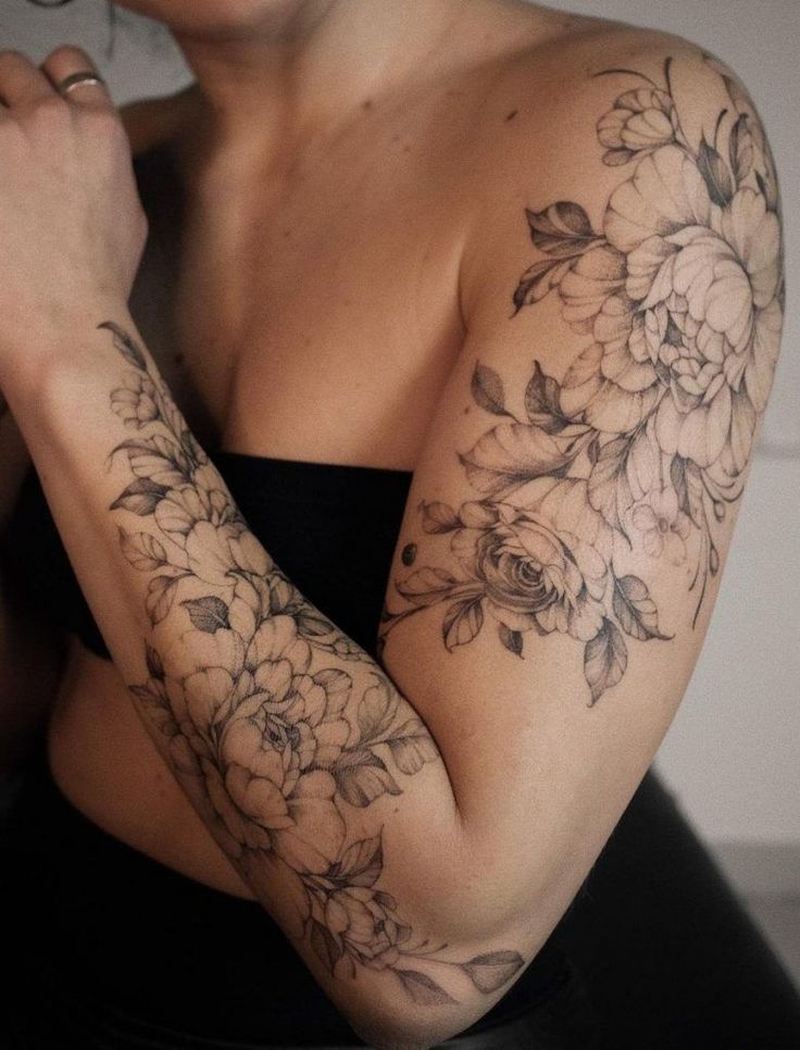 a woman with flowers on her arm and arms