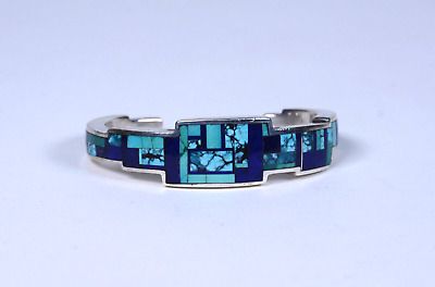 Navajo Bracelet by Ray Tracey: Lapis blue stones and mixed stones inlaid | eBay Modern Blue Multi-stone Jewelry, Blue Multi-stone Bangle Jewelry, Blue Multi-stone Bangle, Southwestern Style Blue Inlay Bracelets, Blue Inlay Bracelet Jewelry, Blue Inlay Bracelet, Artisan Blue Bracelets Collectible, Blue Modernist Jewelry With Polished Finish, Modernist Blue Jewelry With Polished Finish