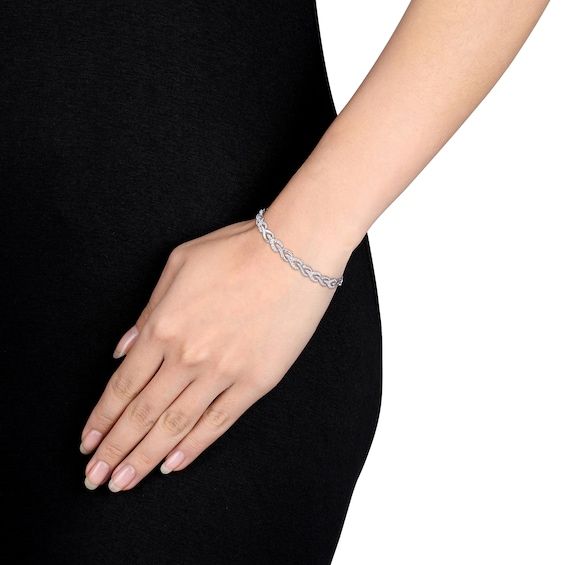 Reinvent your style with the elegant braided design of this diamond alternating finish link bracelet in sterling silver. Crafted in sterling silver Braided wishbone-shaped links shimmer with alternating polished and diamond with beaded detailing finishes. Captivates with 1 ct. t.w. of diamonds This 7.0-inch bracelet secures with a box clasp. Elegant Silver Braided Bracelet, Elegant Round Sterling Silver Braided Bracelets, Classic Formal Braided Bracelet, Silver Diamond Cut Chain Bracelet Fine Jewelry, Elegant Diamond Cut Link Chain Bracelet, Elegant Sterling Silver Link Bracelet In White Gold, Elegant White Gold Sterling Silver Link Bracelet, Elegant White Gold Braided Bracelet For Gift, Elegant Sterling Silver Link Bracelet