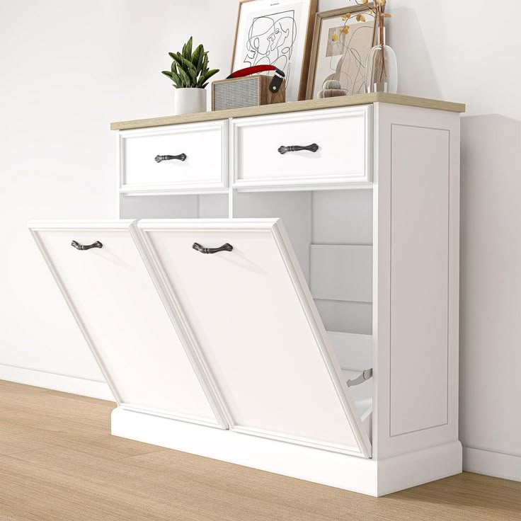 a white cabinet with two open doors on top