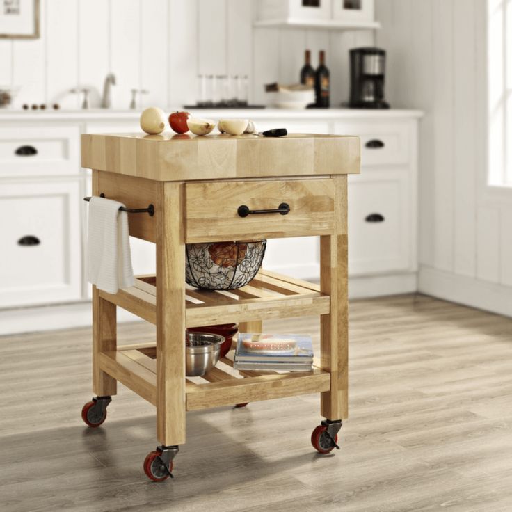 a kitchen island cart with two baskets on the top and one drawer open to hold food