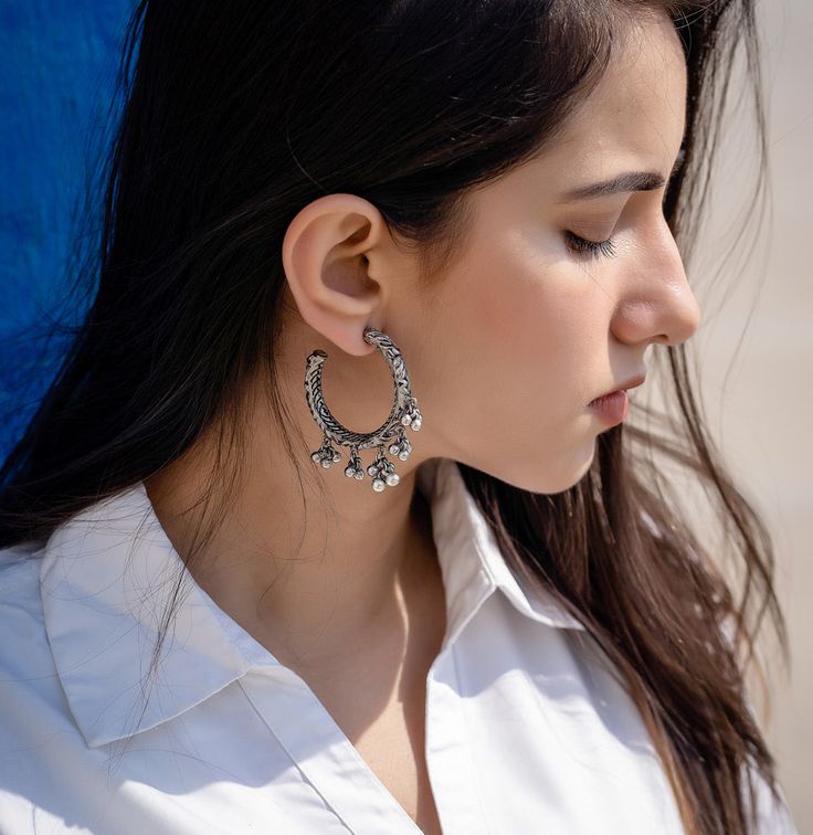 Silver Traditional Hoops (small) : Reviving the old traditional form of tribal jewelry, handcrafted silver plated hoops with Indian motifs carving and ghunghroos. Statement making hoops for all looks Traditional Oxidized Hoop Earrings For Festive Occasions, Traditional Sterling Silver Hoop Earrings, Handmade Danglers For Navratri Festival, Nickel-free Traditional Chandbali Hoop Earrings, Traditional Chandbali Hoop Earrings, Nickel-free, Traditional Chandbali Hoop Earrings Nickel Free, Oxidized Temple Jewelry Danglers For Festivals, Bohemian Jhumkas For Festivals, Bohemian Sterling Silver Jhumkas With Intricate Design