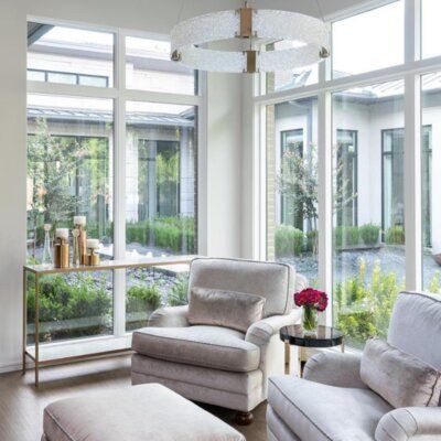 a living room filled with furniture and large windows