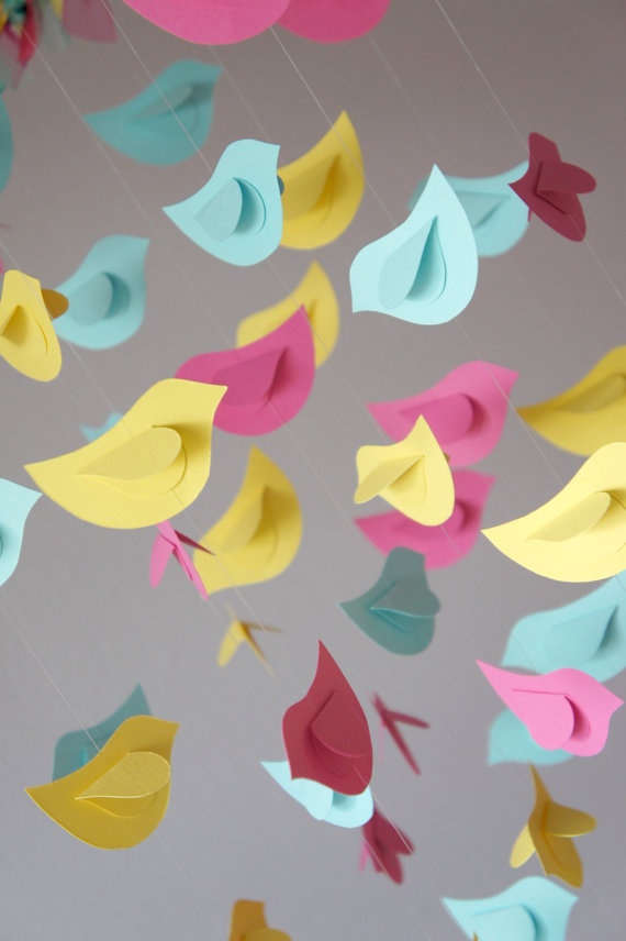 colorful paper birds are flying in the air