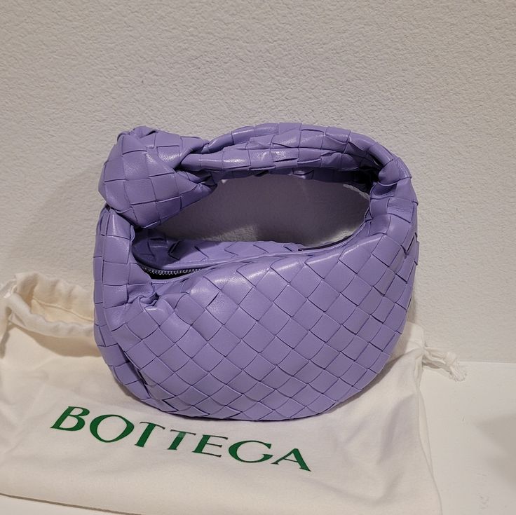 Bottega Veneta Mini Jodie Top Handle Handbag With Single Compartment. Intrecciato Lambskin Leather In Wisteria (Lilac). Made In Italy. Brand New And Never Worn. Comes With Dust Bag And Tags. 11"L X 9"H X 3"W Luxury Purple Pouch Bag, Designer Purple Shoulder Bag With Removable Pouch, Designer Purple Top Handle Shoulder Bag, Designer Purple Shoulder Bag, Luxury Lavender Rectangular Bag, Designer Purple Bags, Mini Jodie, Bottega Veneta Bags, Top Handle Handbags