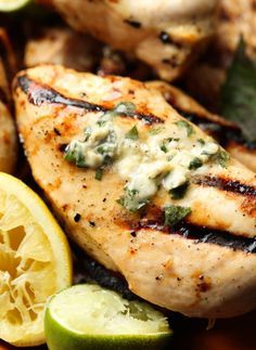 grilled chicken with lemons and lime wedges on the side for garnish