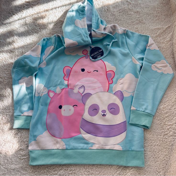 Squishmallows X Dolls Kill Hoodie / Dress Size Medium (Oversized Fit) All Over Cloud Print Baby Blue With Pink & White Swish Mallows 24” Underarm To Underarm 19” Shoulder To Shoulder 30” Shoulder To Hem New With Tags In Original Packaging Blue Hooded Sweatshirt With Cartoon Print, Playful Winter Hoodie, Cute Long Sleeve Top With Drawstring Hood, Cute Blue Hoodie With Cartoon Print, Kawaii Long Sleeve Hoodie With Cartoon Print, Cute Multicolor Cotton Hoodie, Blue Harajuku Style Long Sleeve Sweatshirt, Blue Long Sleeve Harajuku Sweatshirt, Playful Blue Winter Sweatshirt