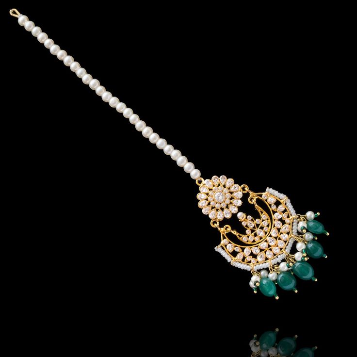 This regal set befitting a queen's closet, pays tribute to Mughal royalty and is the classiest way to embrace the festive season! A charmingly curated set, intricately detailed with the rich emerald drops and garnished with lush CZ and faux pearl beads. Approximate earrings length is 2.5". This set is available in 4 options: Necklace + Earrings Necklace + Earrings + Teekah Necklace + Earrings + Teekah + Jhoomar/passa Necklace + Earrings + Teekah + Jhoomar + Finger Ring Please select the desired Elegant Chandbalis With Cutdana For Navratri, Elegant Chandbalis With Cutdana For Diwali, Elegant Cutdana Chandbalis For Navratri, Elegant Chandbalis For Diwali Festivities, Elegant Kundan Chandbalis For Festive Occasions, Elegant Chandbalis For Navratri Festive, Elegant Festive Chandbali Traditional Wear, Elegant Festive Chandbalis For Navratri, Elegant Navratri Festive Chandbalis