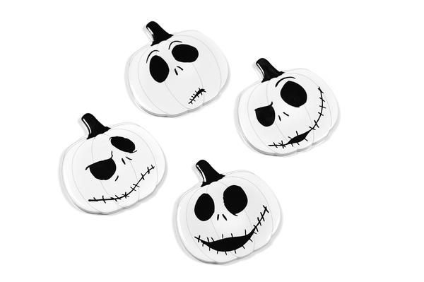 three white pumpkins with black faces on them