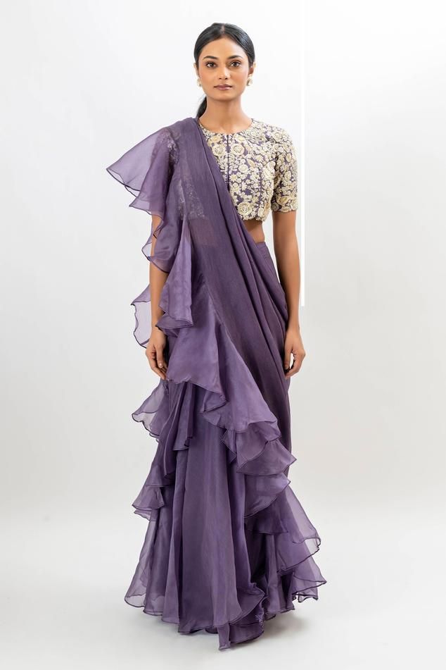 Dusty purple pre-draped saree with ruffle detailing. Paired with a blouse with all over floral hand embroidery.
Components: 2
Pattern: Hand Embroidery
Type Of Work: Floral, Beads, Sequins
Neckline: Round Neck
Sleeve Type: Half Sleeves
Fabric: Blouse: Bamber silk, Saree: Chiffon and Silk organza, Lining: Taffeta
Color: Purple
Other Details: 
Padded blouse
Attached inner lining
Occasion: Sangeet - Aza Fashions Purple Pre-draped Saree For Wedding, Bollywood Style Ruffled Saree For Evening, Elegant Purple Tissue Silk Pre-draped Saree, Purple Silk Pre-draped Saree For Wedding, Elegant Festive Dupatta With Ruffles, Silk Saree With Ruffles For Evening, Party Purple Silk Pre-draped Saree, Silk Blouse Piece With Ruffles For Reception, Semi-stitched Ruffled Blouse Piece For Reception