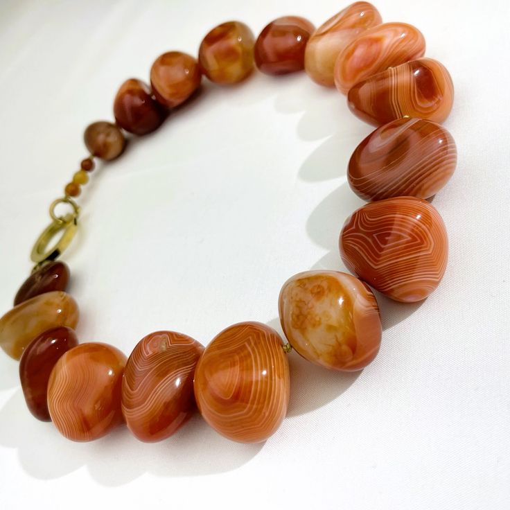 Carnelian stones rejuvenate themselves when exposed to the sun.  Called red Carnelian, the color is more orange than red. The veining in the stone and the high polish make it attractive. The stone represents life in the magical world. The choker measures 18.5 IN/47 CM and you can request an extender. Red Carnelian, Carnelian Jewelry, Carnelian Necklace, Carnelian Stone, Magical World, Vibrant Orange, Stone Necklace, Precious Stones, Orange Color