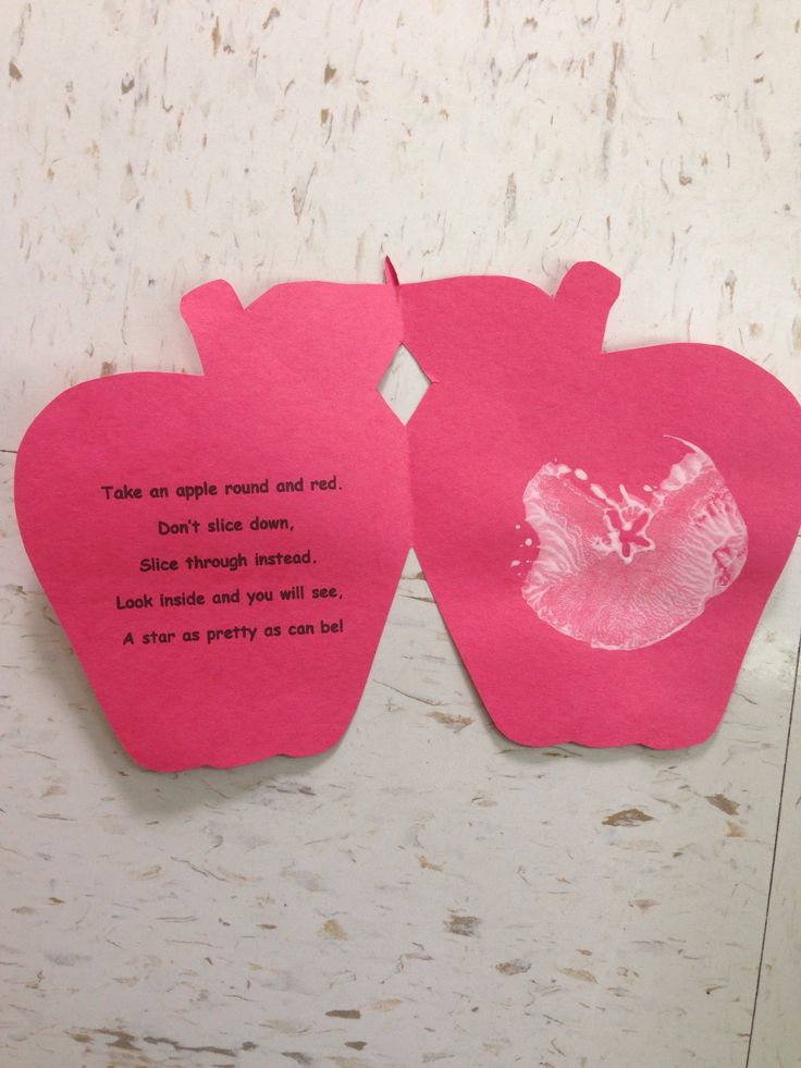 two pieces of pink paper with words written on them and an apple cut out to look like hearts