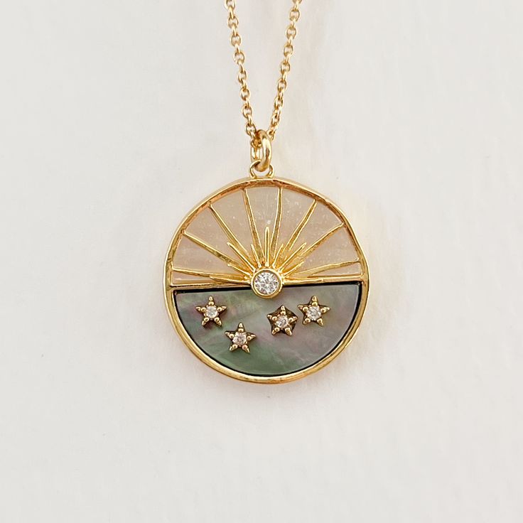 Our Sunset necklace features a round hand crafted charm in white and smoke mother of pearl with a gold inlay of the sun and finished with CZ crystal stars. Measures: 17" length w/ 2" extender Gold filled. Care: Avoid contact with cleansers, fragrance and salt water. Wipe clean with a soft dry cloth. Sunset Necklace, Sun Jewelry, Sun Charm, Sun Necklace, Sun And Stars, Crystal Stars, Dream Nails, Star Necklace, Gold Charm