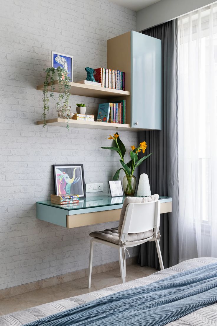 a bed room with a neatly made bed and a desk in front of a window