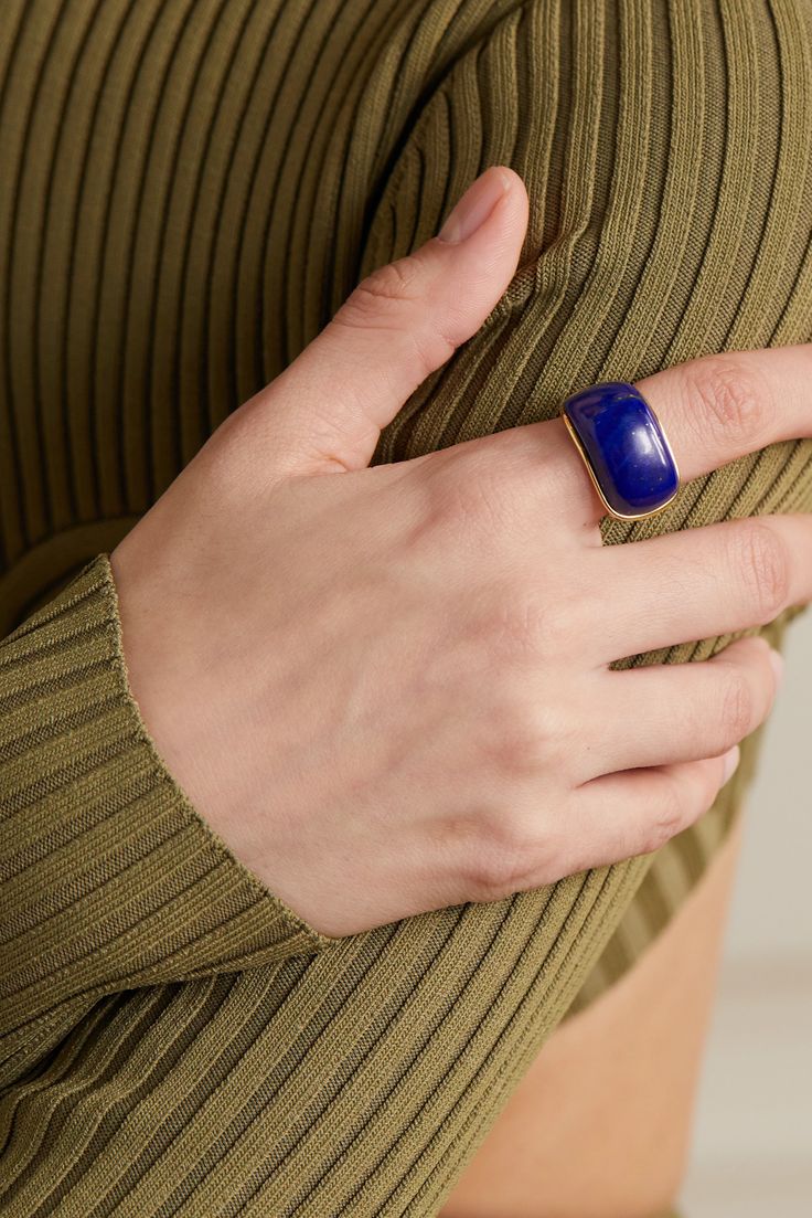 Fernando Jorge's pieces are created in close collaboration with master craftsmen and lapidaries in São Paulo. Handmade from 18-karat gold, this 'Oblong' ring is set with a sizable lapis lazuli - take note of the beautiful, naturally occurring veins that give the vibrant stone a cool marbled effect. Wear yours on your index finger for the biggest impact. Timeless Blue Signet Ring With Polished Finish, Blue Enamel Ring With Gemstone In Fine Jewelry Style, Blue Enamel Ring With Gemstone Fine Jewelry, Blue Enamel Ring With Gemstone, Timeless Blue Gemstone Signet Ring, Elegant Blue Enamel Ring With Gemstone, Luxury Blue Rings With Polished Finish, Blue Lapis Lazuli Fine Jewelry Rings, Fine Jewelry Blue Lapis Lazuli Ring