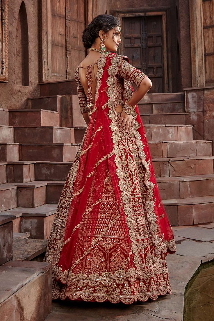 Blood red attached can-can lehenga with gota, sequin, dabka and crystal work. Comes with padded blouse and dupatta.
Component: 3
Pattern: Embroidered
Type Of Work: Gota, Sequin, Dabka and Crystals
Neckline: V neck
Sleeve Type: Half
Fabric: Velvet
Color: Red
Other Details: 
Scalloped hems
Low back with tie up and tassels
Dupatta with scallop border
Note: The veil worn by the model is not for sale
Note: The veil will be available on request, please contact our customer service for more details
Occ Red Velvet Lehenga, Designing Clothes, Dori Work, Blouse Yoke, Velvet Lehenga, Raw Silk Lehenga, Making Clothes, Lehenga Blouse, Velvet Color