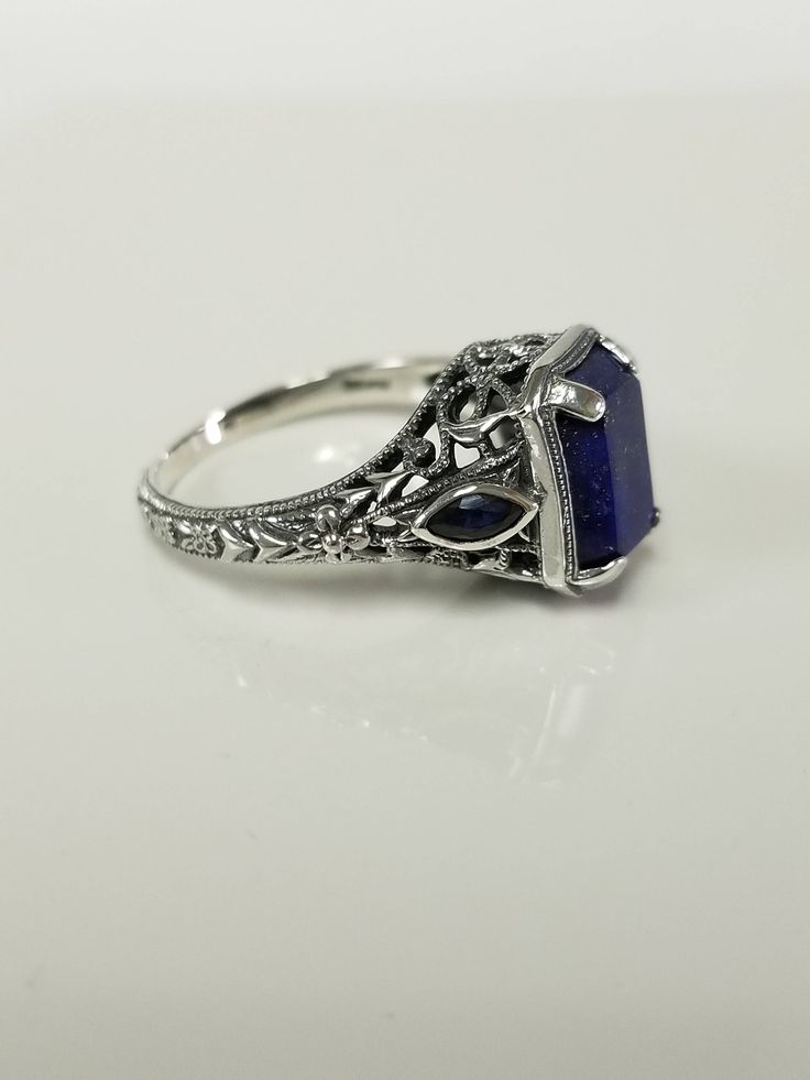 "Thanks for shopping our vintage estate store. We tend to sell well below wholesale and truly hope you enjoy all of our items. Many of the items are one of a kind, so please enjoy scrolling through the pictures and hopefully something will catch your eye. Brown spots are from the camera or reflections Estate sterling silver 925 natural 2ct lapis lazuli sapphire filigree vintage style ring. Last 3 pictures are natural light. Retails $249 on sale $99 Ring size: please select a size Setting: 3/8\" Vintage Sterling Silver Filigree Ring, Vintage Sapphire Jewelry For Formal Occasions, Elegant Nickel-free Engraved Ring For Anniversary, Vintage Sterling Silver Filigree Ring Collectible, Vintage Sapphire Ring Gift, Vintage Blue Filigree Ring For Anniversary, Vintage Filigree Ring Stamped 925 As Gift, Vintage Sapphire Jewelry With Emerald Cut, Vintage Sapphire Emerald-cut Jewelry