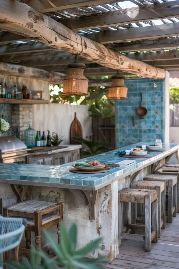 an outdoor kitchen with blue tiles on the walls