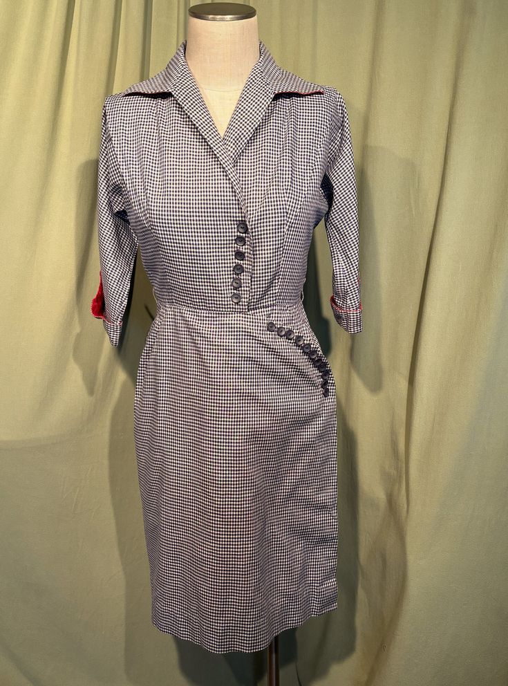 This is a wonderful vintage dress from the 40s. Labeled R & K Originals, Personally Yours. No size tags. The bust measures 36", waist 28", hip 36", see measurements below.   Made of a blue & white gingham check cotton with red lining.  It has 3/4 length sleeves with flared cuffs with button accents & red lining. The sleeves are not "Set-on" sleeves, but part of the front & back panels. No pockets. Below knee length. Collared V neckline. The collar is lined in red too & has straight points. It has string belt loops, but no belt (a red belt would be divine!). Fit and flare shape with a stitched waist & softly flared skirt. The entire skirt is lined in red cotton. The bodice has a single pleat on each side running from the shoulder seam to the center bust on the diagonal. Buttons down the fro Retro Fitted Knee-length Plaid Dress, Fitted Retro Knee-length Plaid Dress, Fitted Knee-length Retro Plaid Dress, Fitted Retro Plaid Vintage Dress, Fitted Plaid Retro Vintage Dress, Retro Plaid Fitted Vintage Dress, Fitted Gingham Retro Vintage Dress, Retro Fitted Gingham Vintage Dress, Fitted Vintage Gingham Dress In Retro Style