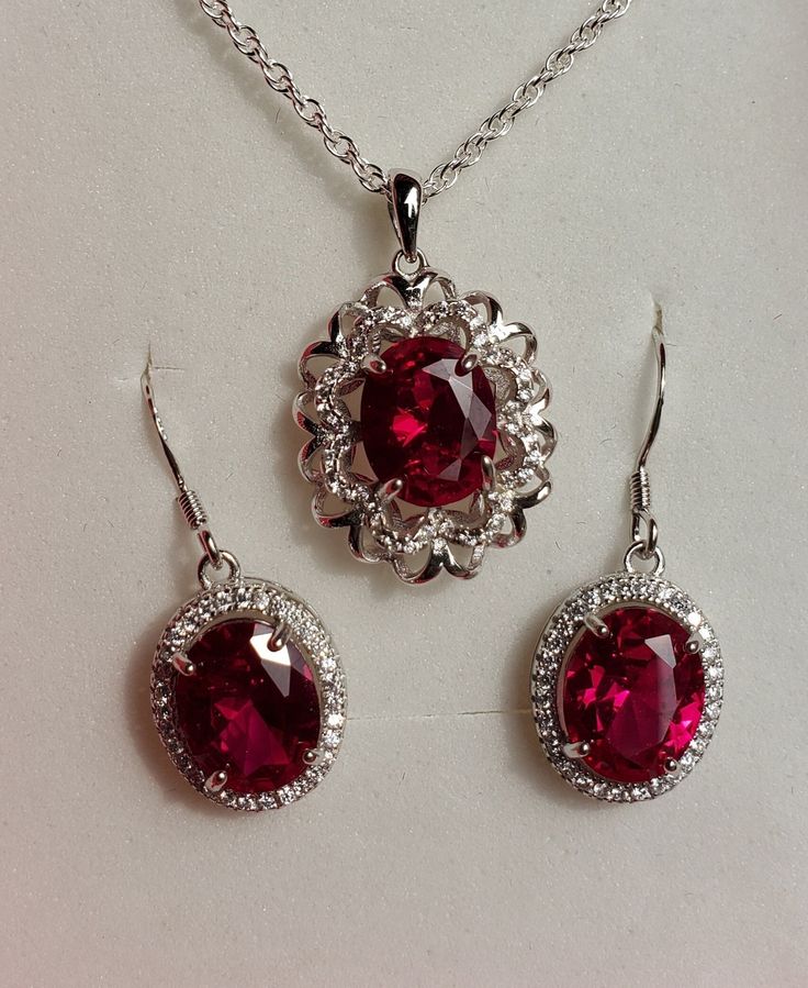 "Beautiful Deep Red Gem Necklace And Earring Set, 8x10mm Lab Grown Ruby Gems, 925 Sterling Silver Rhodium Plated Pendant With Cubic Zirconia Trim, 18\" Sterling Chain. 925 Sterling Rhodium Plated Earrings, Ear Wire Style. Gift Box Included." Luxury Red Danglers As Gift, Ruby Wedding Jewelry, Luxury Lab-created Ruby Necklace Gift, Ruby Jewelry Aesthetic, Red Sterling Silver Fine Jewelry, Formal Sterling Silver Gemstone Jewelry Sets, Red Gemstone Accented Jewelry For Formal Occasions, Red Gemstone-accented Jewelry For Formal Occasions, Red Sterling Silver Jewelry With Gemstone Accents