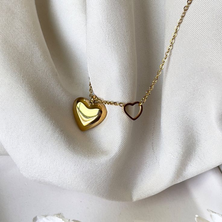 This 2in1 Golden Heart Necklace is perfect for making a statement.  Crafted with 18k gold, it is both dainty and feminine, yet adjustable to enhance your sophisticated style.  Its waterproof, hypoallergenic, and anti-tarnish components guarantee a timeless and classy look that you can enjoy for years to come. ☆Waterproof gold necklace ☆Hypoallergenic necklace ☆Anti tarnish ☆40cm + 5cm extension for extra comfort and styling ✨ABOUT CRESCENT JEWELRY DESIGNS All jewelry is made by Crescent Jewelry Designs in the heart of Nashville Tennessee. Designing unique and beautiful jewelry is our passion, and our goal is to make sure you are 100% satisfied with the products. Each piece is made with hypoallergenic earring posts and free from lead and nickel. If you have any questions or concerns regardi Gold Stainless Steel Heart Necklace For Mother's Day, Gold Heart Necklace Tarnish Resistant For Her, Gold Locket Necklace With Clavicle Chain As Gift, Minimalist Chain Necklace For Valentine's Day, Gold Minimalist Heart Necklace With Round Pendant, Minimalist Locket Necklace For Gift, Gold Double Heart Necklaces For Her, Gold Hypoallergenic Necklace For Her, Minimalist Double Heart Charm Necklace With Adjustable Chain