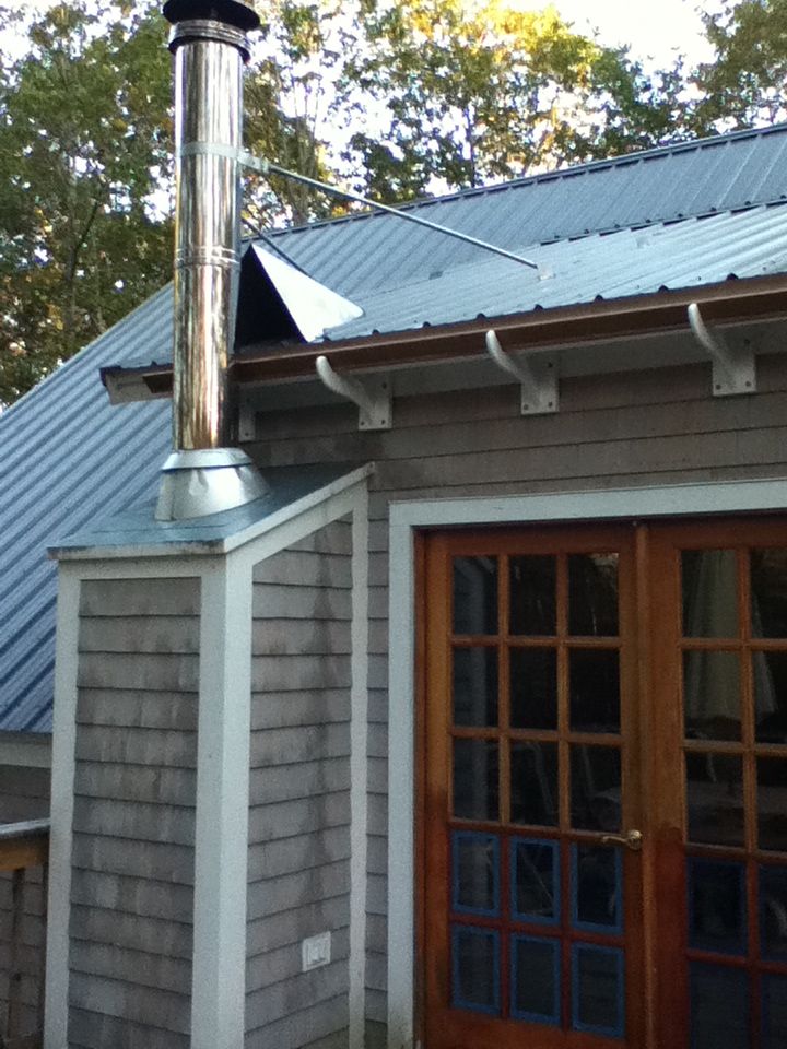 a house with a metal chimney on the roof