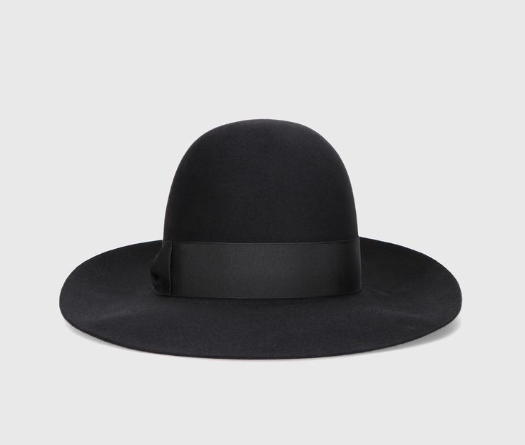 The Eleonora hat is a timeless symbol of Borsalino excellence. The model is made from superior quality smooth folar felt, known for its smooth finish and soft touch, ensuring superior comfort and durability over time. This hat is unlined and offers a light and comfortable fit. The design features an open crown and a 4 cm wide grosgrain ribbon. The brim is wide and measures approximately 8 cm. Each Borsalino felt hat takes seven weeks to be handcrafted by our skilled artisans at the Maison in Alessandria, whose passion and craftsmanship are expressed in every single piece. The Borsalino handmade production process involves more than 50 steps and is passed down from generation to generation. Composition: 100% Felt Classic Solid Felt Hat With Flat Crown, Modern Wide Brim Hat For Formal Occasions, Elegant Fitted Hat With Flat Crown, Formal Solid Fedora With Flat Crown, Chic Fedora With Flat Crown For Formal Occasions, Chic Formal Fedora With Flat Crown, Elegant Black Fedora With Flat Crown, Luxury Wool Fedora With Flat Brim, Luxury Fur Felt Fedora With Flat Brim