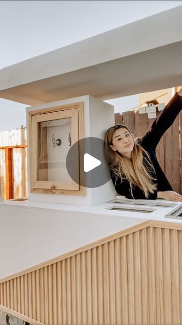 a woman standing on top of a kitchen counter