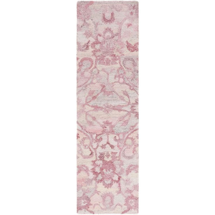 a pink rug with an ornate design on it