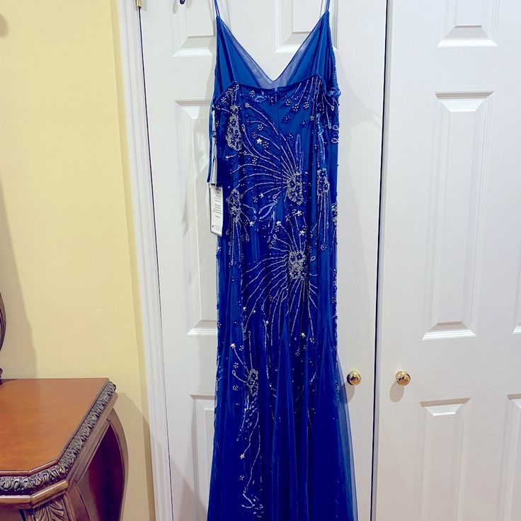 a blue dress hanging on a door