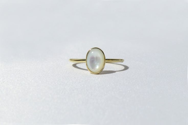 Elegant, simple and truly a classic piece. This mother of pearl ring is made from 14k solid gold or 14k solid white gold material. Set with a natural mother of pearl stone. Each pearl is unique and natural. Whether you're buying this beautiful pearl ring as a gift or for yourself, it will bring forth new beginnings and good luck. Handmade in Los Angeles, CA! Fast Shipping: It will take 1-3 business days to send out your item Packaging: Comes in an upgraded gift box, ready for gift-giving! Pearl Timeless Oval Rings With High Luster, Elegant Moonstone Rings For Formal Occasions, 14k White Gold Moonstone Promise Ring, Classic Yellow Gold Moonstone Ring With Polished Finish, 14k White Gold Birthstone Ring With Polished Finish, Classic Yellow Gold Halo Opal Ring, Elegant Formal Moonstone Rings, Classic Gold Opal Ring In Sterling Silver, White Solitaire Pearl Promise Ring