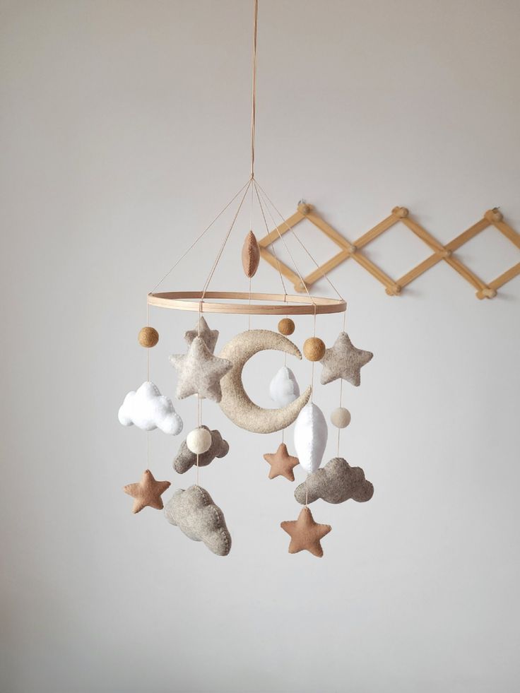 a mobile with stars and clouds hanging from it