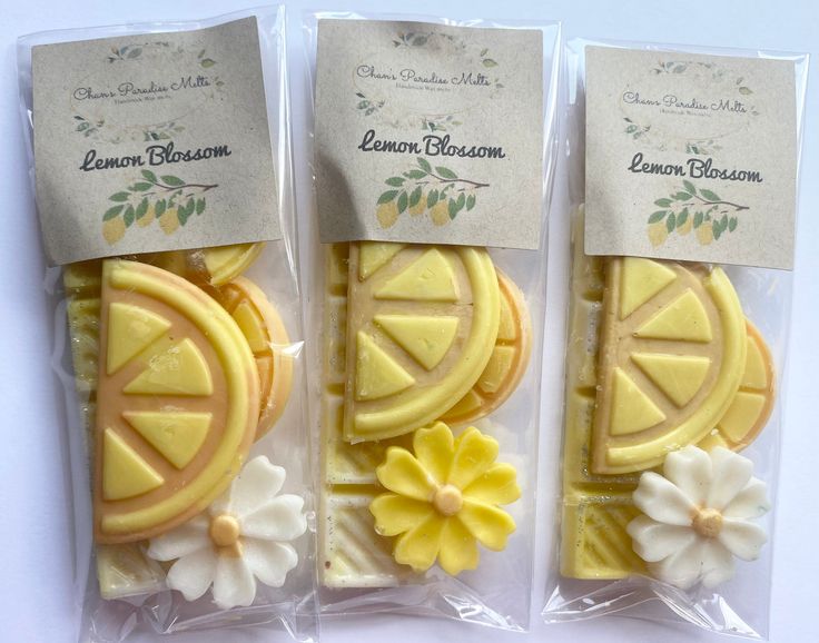 three packaged cookies with lemon slices and flowers