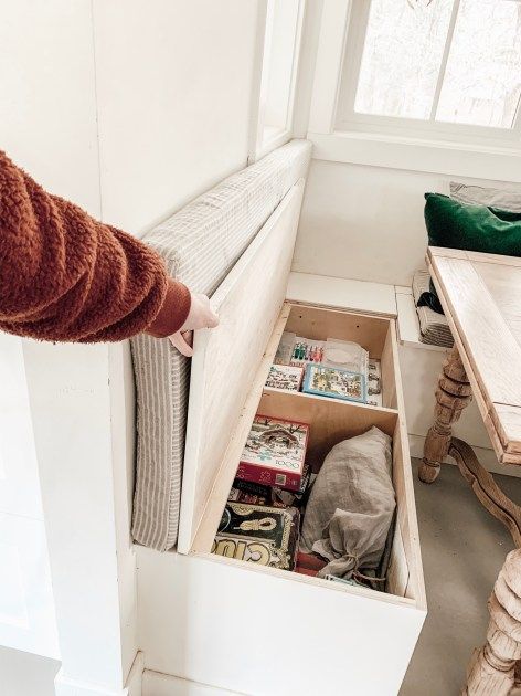 an open drawer in the corner of a room